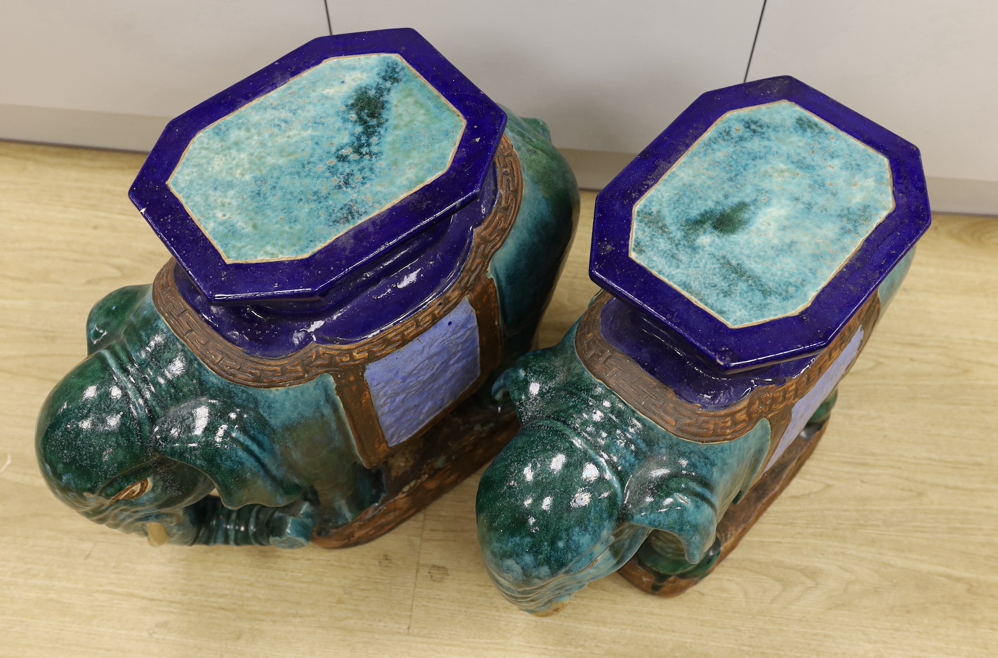 A pair of Chinese Shiwan type polychrome ‘elephant’ tables or stools, 57cm
